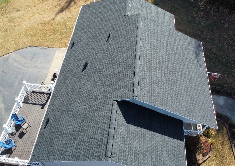 an aerial view of a house with a roof and a deck .