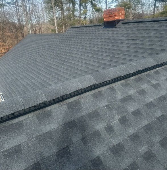 a close up of a roof with a chimney on top of it .