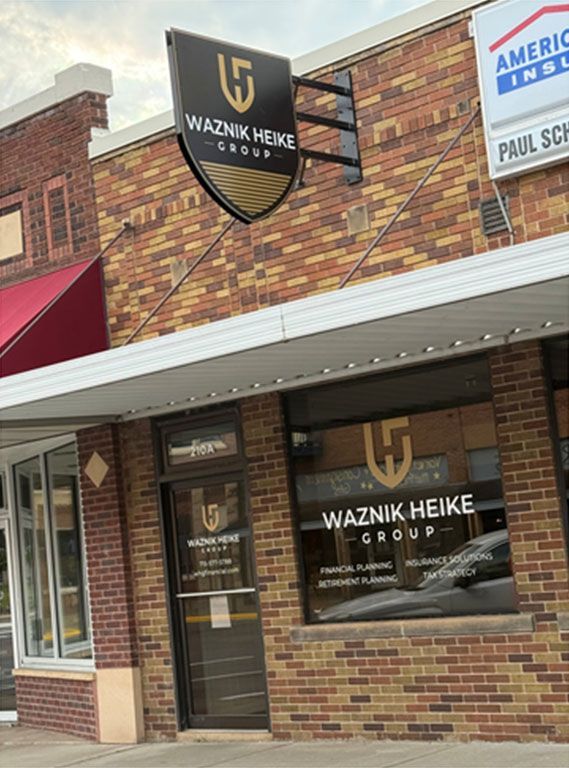 Waznik Heike Group office exterior with sign and window display.