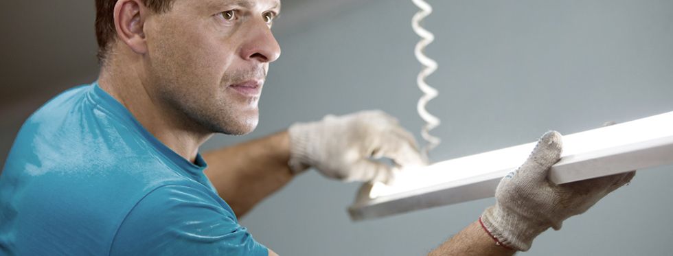 Electrician Installing Fluorescent Lamp