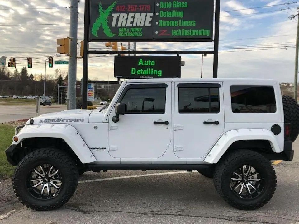 Side view of a white Jeep