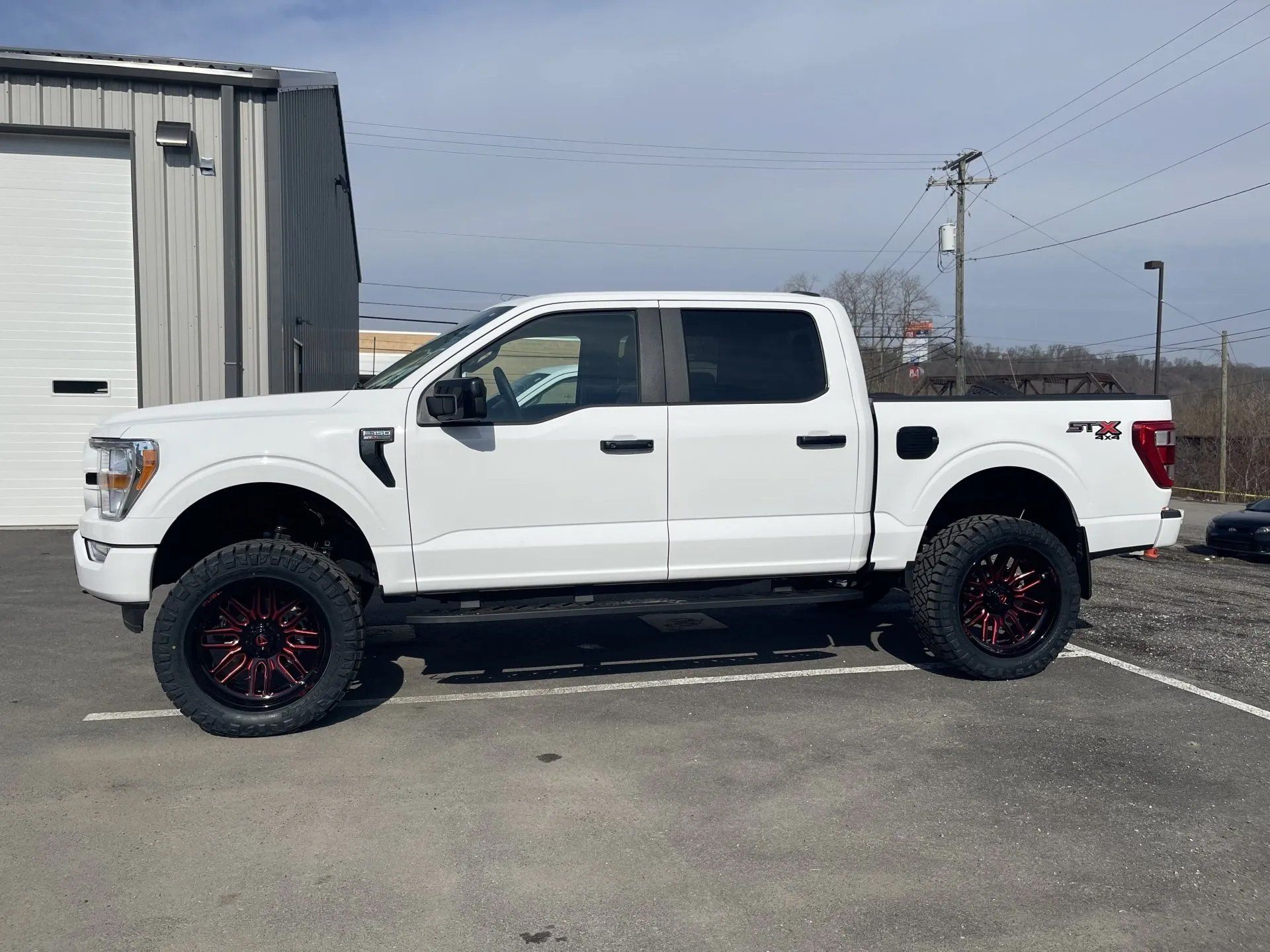 White pick up truck with red mags