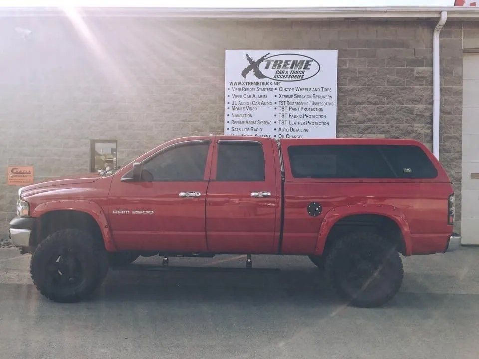 Red pick up truck with black mags