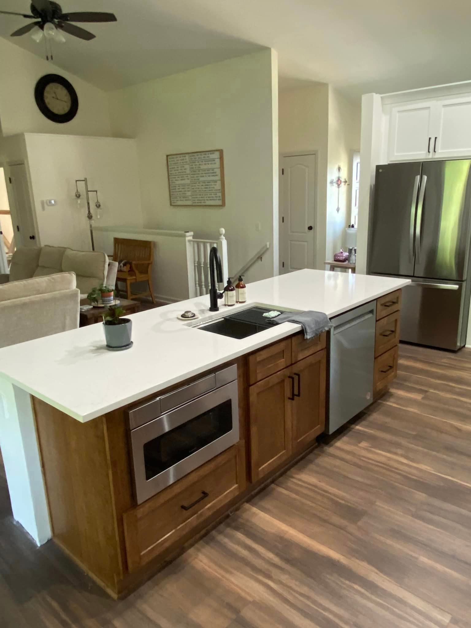 A kitchen with stainless steel appliances and wooden cabinets