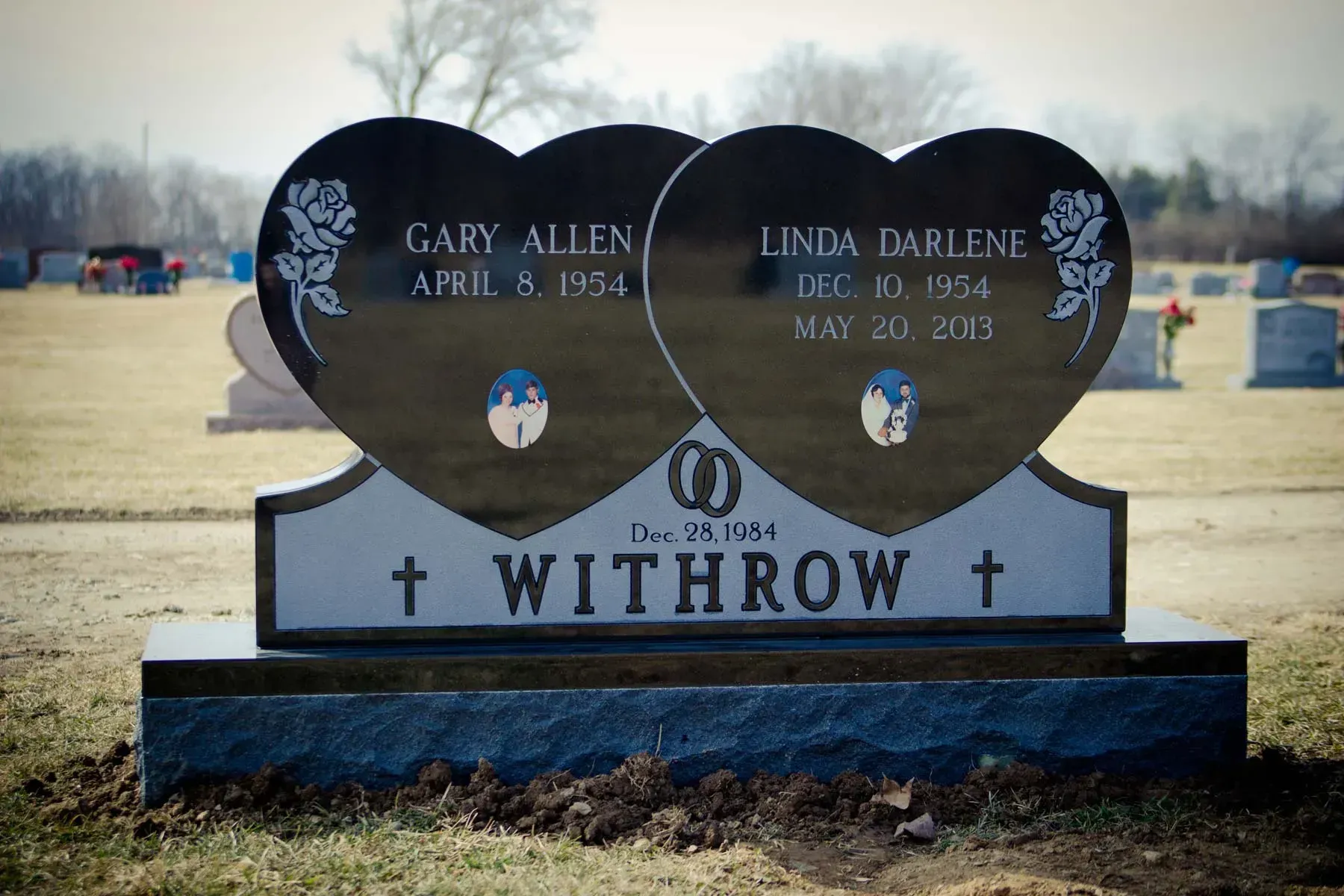 Heart-shaped double gravestone with names Gary Allen and Linda Darlene Withrow in a cemetery.