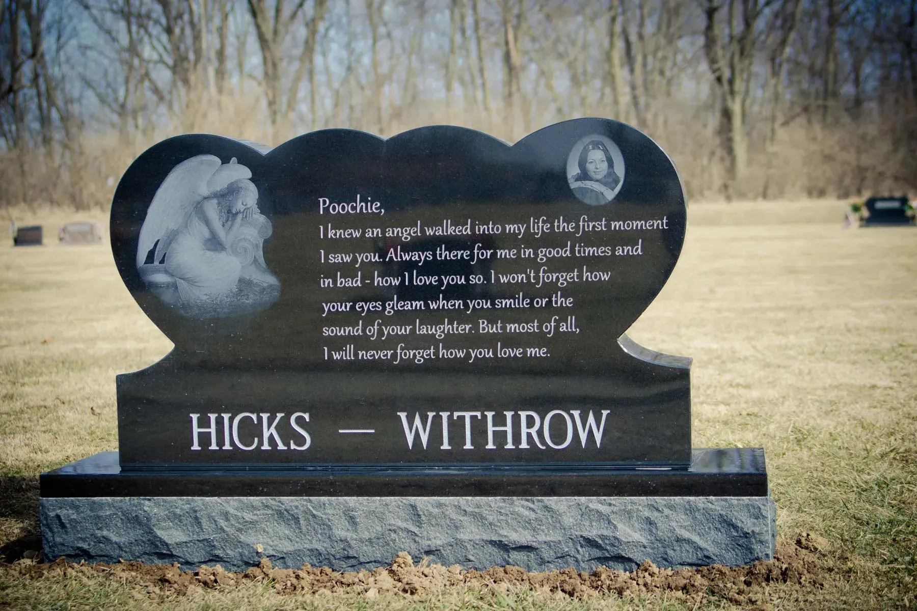 Black gravestone memorial in a cemetery with engraved portrait and the name “HICKS - WITHROW”