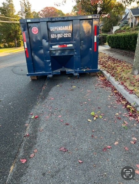 A blue dumpster labeled 