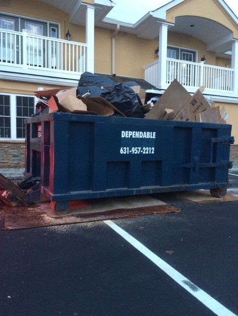Dark blue dumpster labeled 