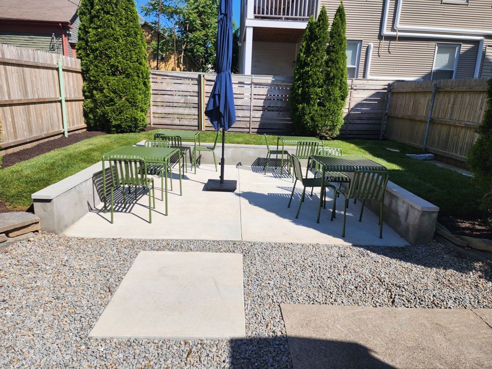 A backyard with tables and chairs 