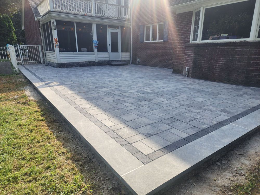 A brick house with a patio in front of it