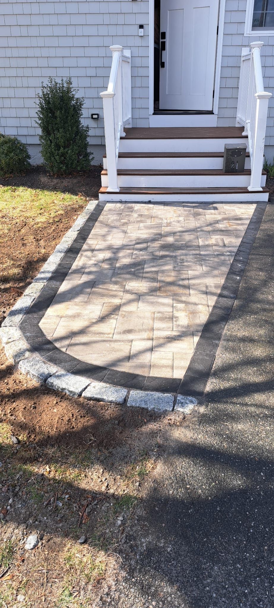 A walkway leads to the front door of a house