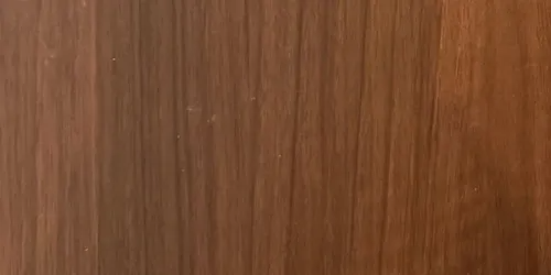 Close-up of vertical wooden planks with varying shades of brown and reddish-brown.