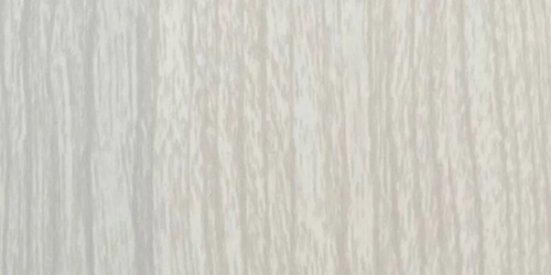 Light-colored wood grain background with vertical lines, showing texture and variation in tone.