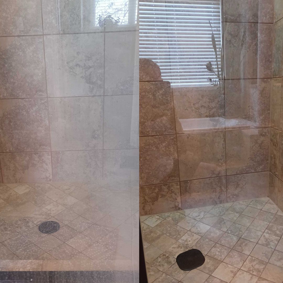 A bathroom with a walk in shower and a window with blinds.
