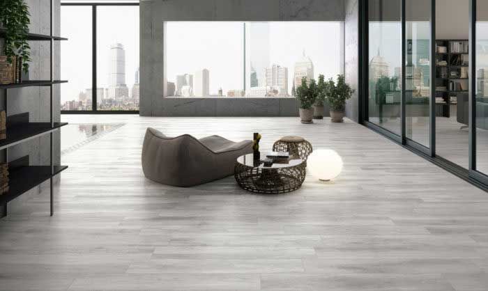 A living room with a table and chairs and a large window.