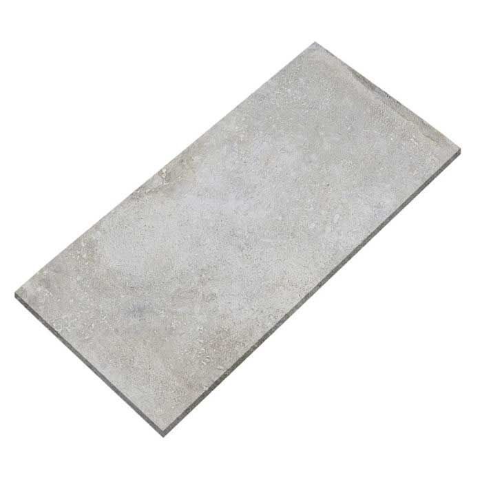 A gray tile is laying on a white surface.