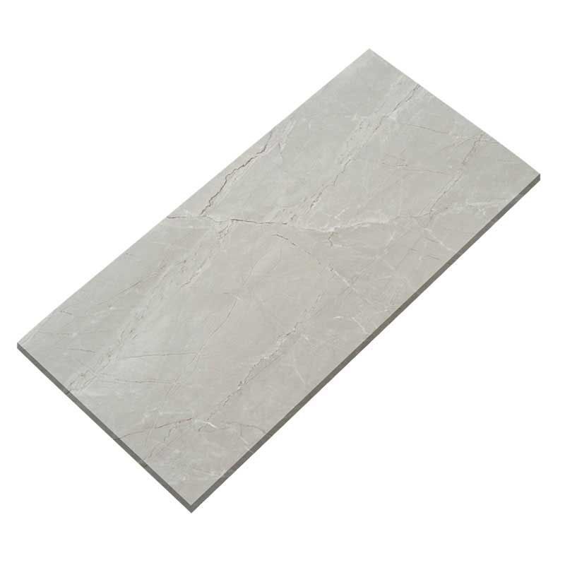A gray tile is laying on a white surface.