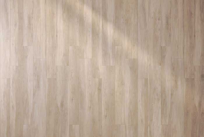 A close up of a wooden floor with a shadow on it.