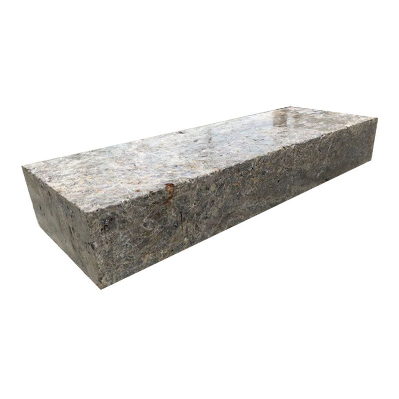 A brick is sitting on a white surface.