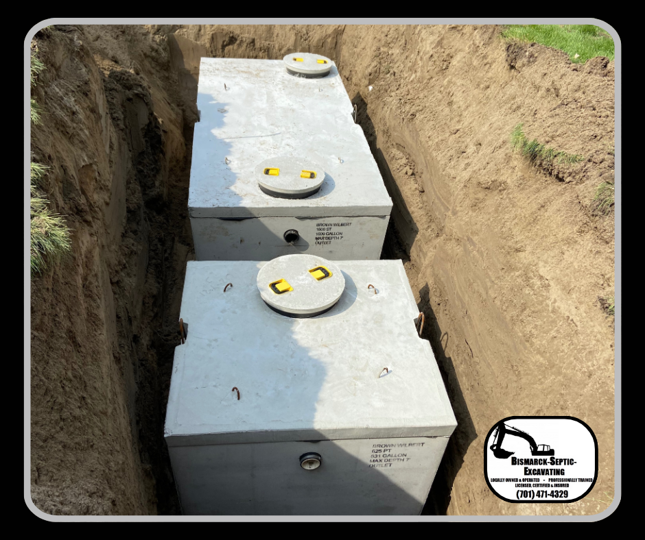 Two concrete septic tanks are sitting in a trench.