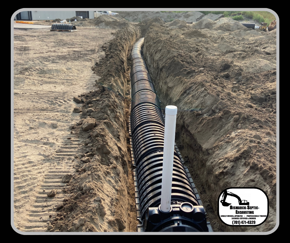 A large pipe is being installed in a trench.