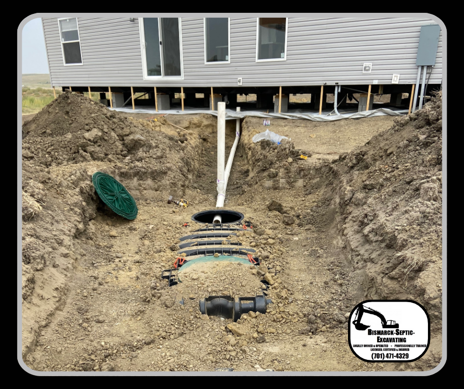 A septic tank is being installed in the dirt in front of a house.