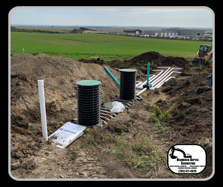 A septic system is being installed in a field.