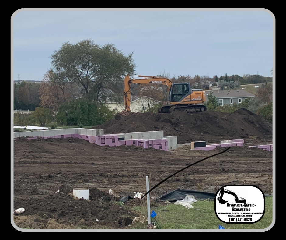 An excavator is digging a pile of dirt in a construction site.