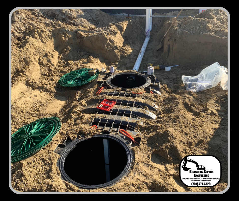 A septic tank is being installed in the dirt.