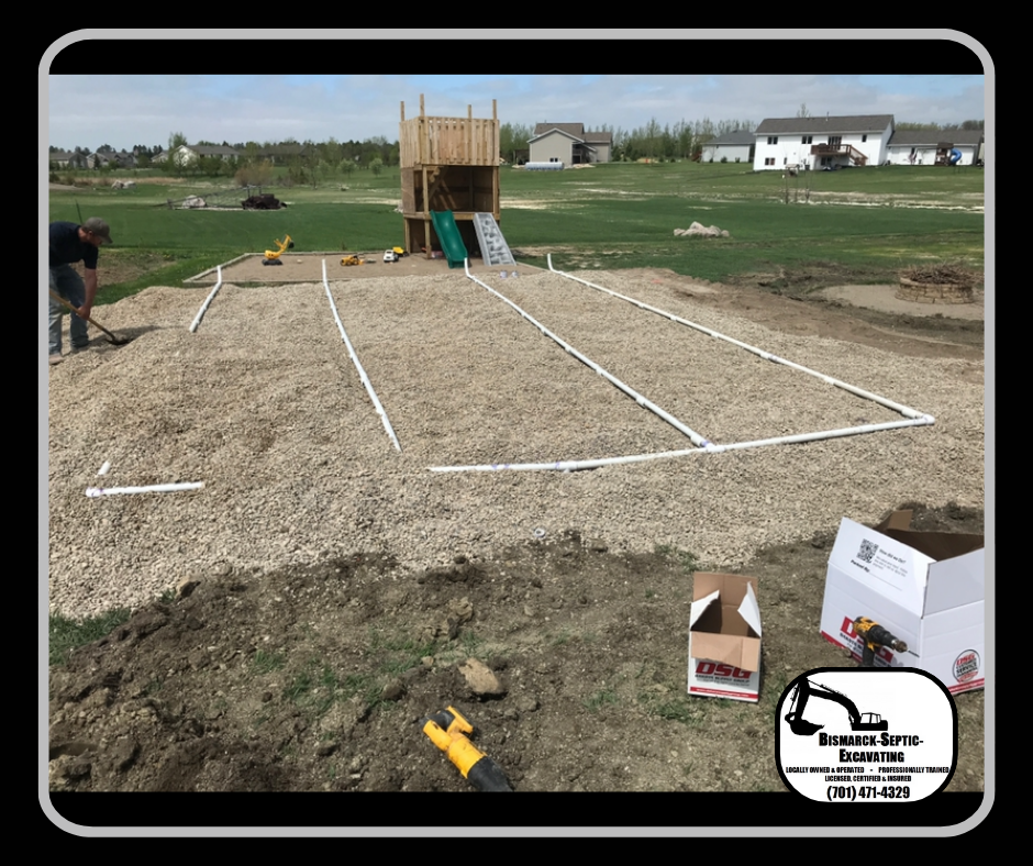 A volleyball court is being built in a backyard.