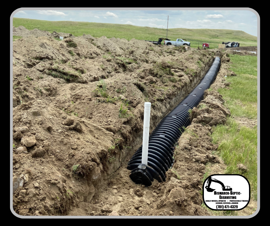 A large pipe is laying in the dirt in a field.