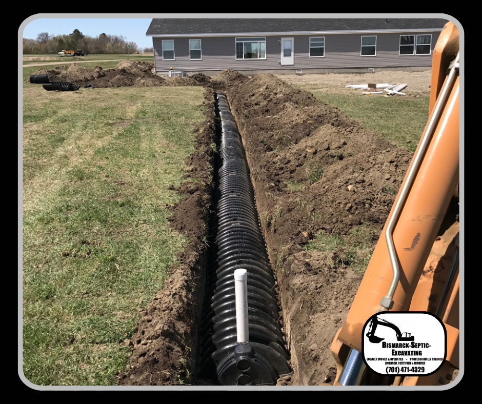 A large pipe is being installed in the dirt in front of a house.