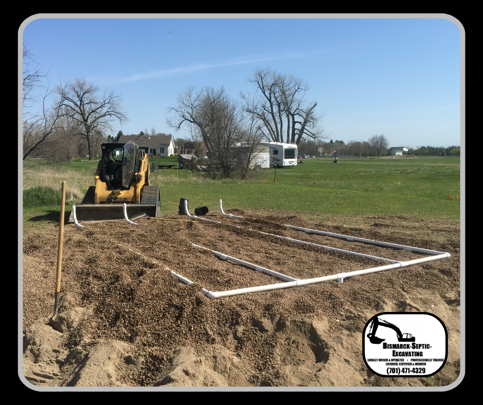 A bulldozer is digging a hole in the dirt in a field.