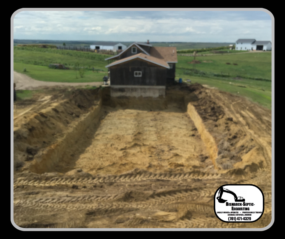 A large pile of dirt is sitting in front of a house.