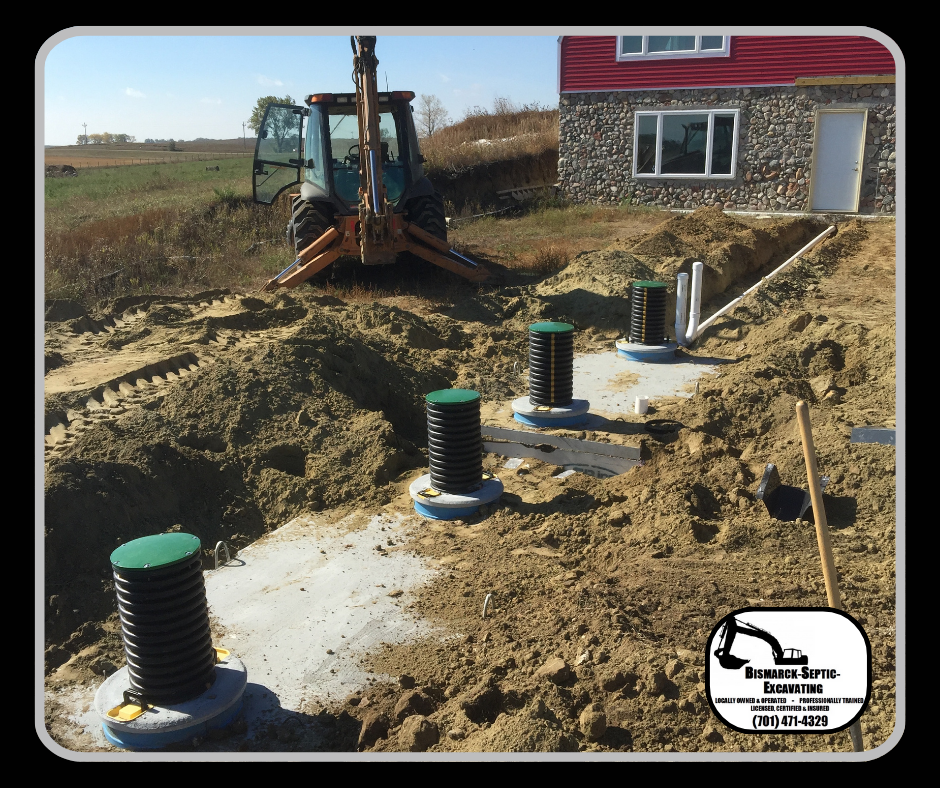 A tractor is digging in the dirt in front of a house.