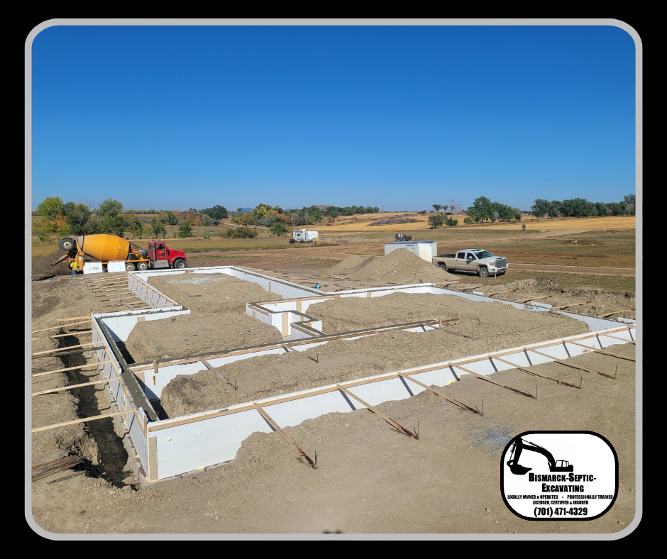 A foundation for a house is being built in a field.