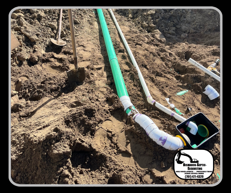 A green pipe is laying in the dirt next to a shovel.