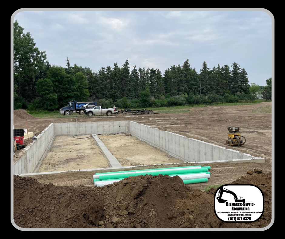 A large concrete foundation is being built in a field.