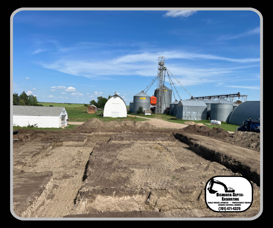A large pile of dirt is sitting in front of a farm.