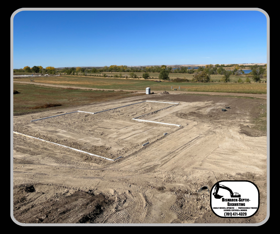 An aerial view of a dirt field with a blue sky in the background.