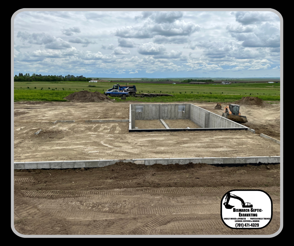 A large concrete foundation is being built in a field.
