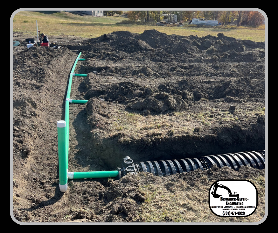 A green pipe is sitting in the middle of a dirt field.
