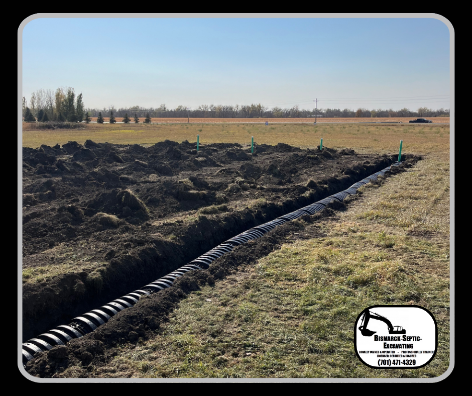 A large pipe is being installed in a field.