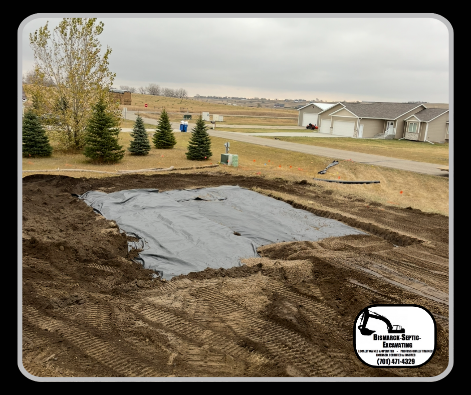 A large hole in the ground with a black tarp on top of it.