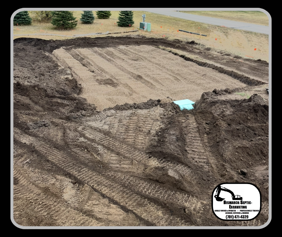 A large pile of dirt is being excavated in a field.
