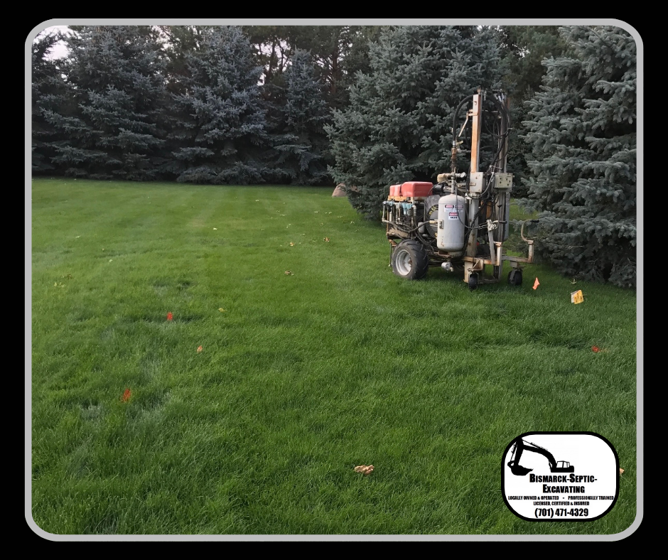 A machine is sitting in the middle of a lush green field.