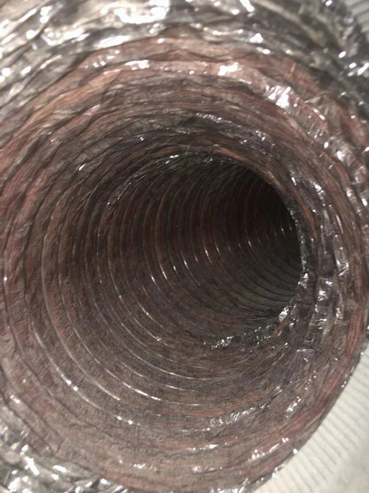 Close-up view down a corrugated metal pipe or duct interior