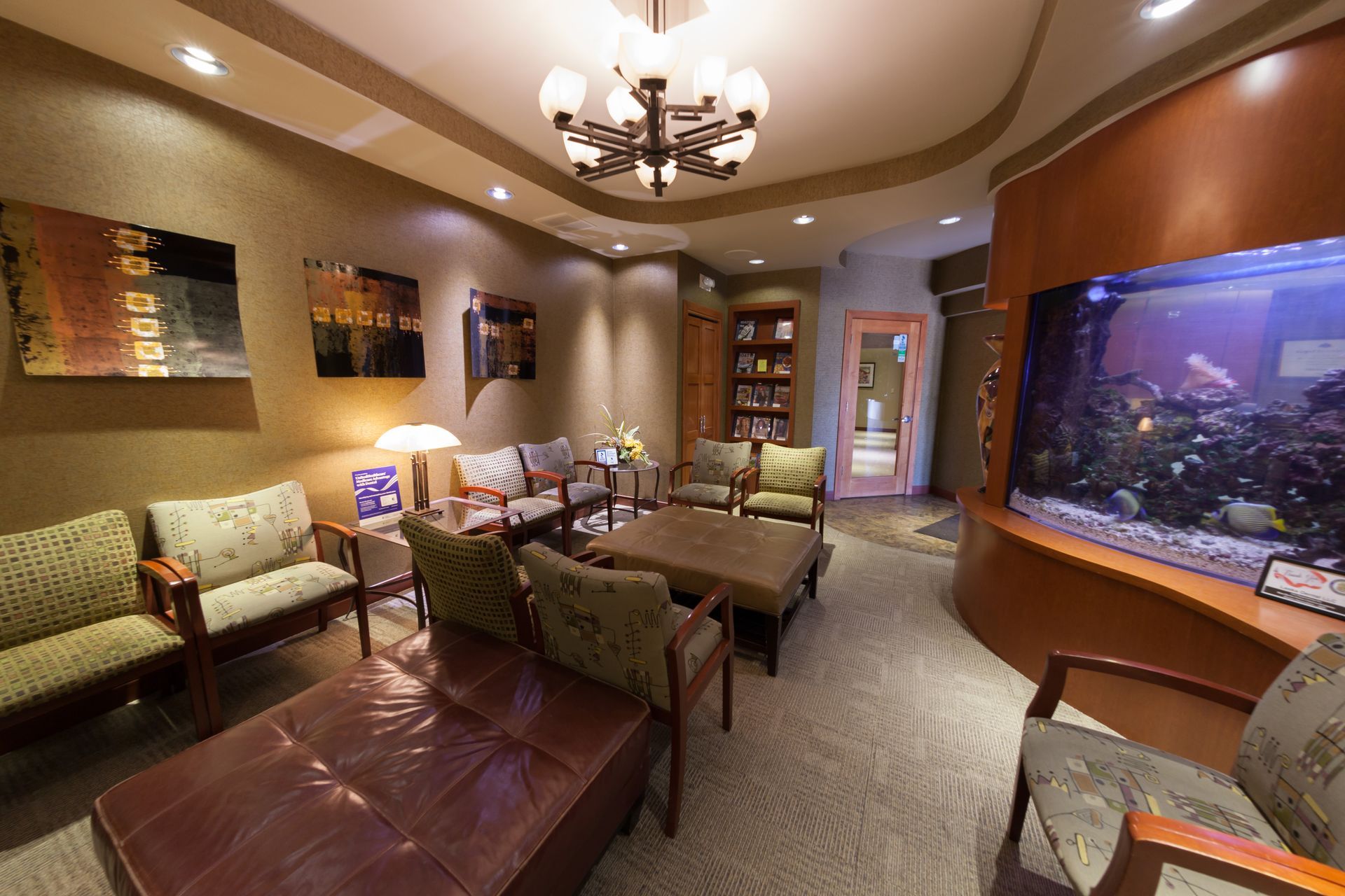 A waiting room with a large aquarium in the corner.