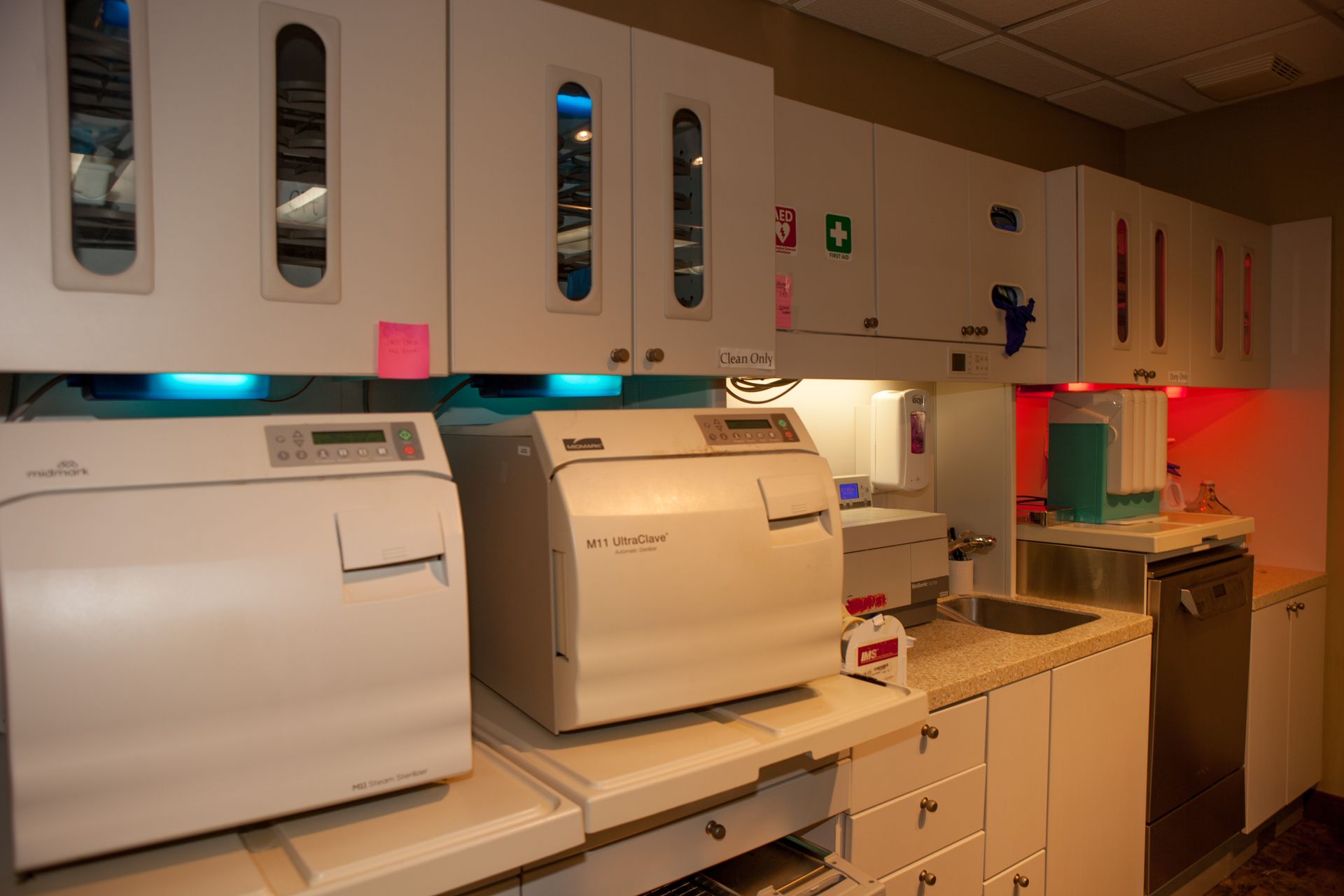 A kitchen with a lot of white cabinets and appliances.
