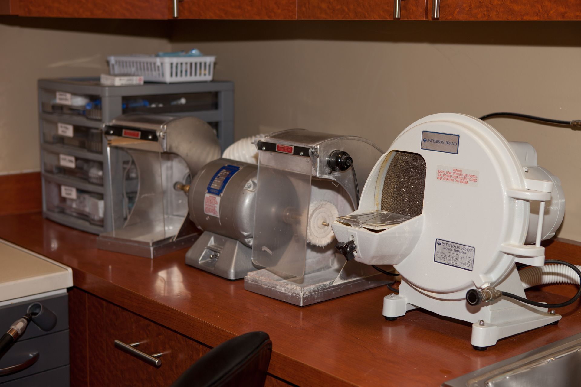 Three machines are sitting on a counter in a kitchen.